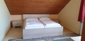 A bed or beds in a room at Penzion Montana