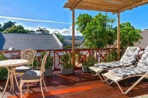 a deck with chairs and a table and a table at Founders Keepers - Leisure Isle in Knysna +12 photos