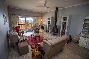 a living room with two couches and a fireplace at Forty Winks in Nottingham Road