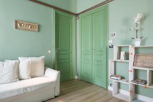 カターニアにあるDuomo Housing Cataniaのリビングルーム(緑のドア、ソファ付)