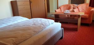 A bed or beds in a room at Penzion Montana