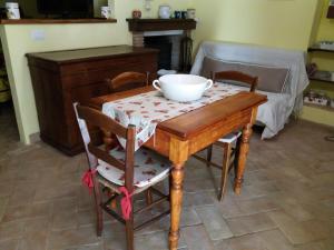 a table and chairs with a bowl on top of it at LA BICO' in Pitigliano