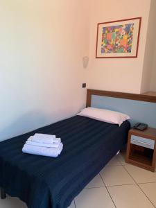 Postel nebo postele na pokoji v ubytování Hotel & Residence La Sibilla Cusiana