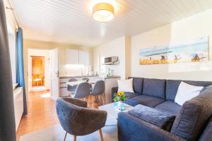 a living room with a couch and chairs and a table at Ferienbungalow Fischerstrand in Binz