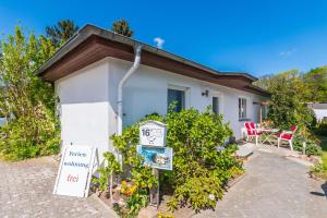 a house with a sign in front of it at Ferienbungalow Fischerstrand in Binz