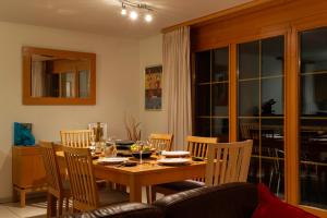 a dining room with a wooden table and chairs at Hafod a Hendre in Lauterbrunnen