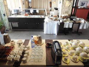 a table with a bunch of cups and plates on it at Hill View Hotel Apartments in Pissouri