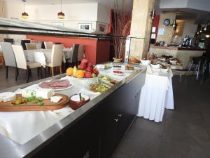 a buffet line with plates of food in a restaurant at Hill View Hotel Apartments in Pissouri
