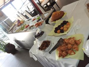 a table with many different types of food on it at Hill View Hotel Apartments in Pissouri