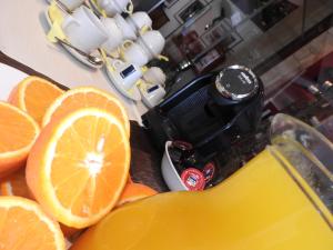 an orange cut in half sitting next to a juicer at Hill View Hotel Apartments in Pissouri