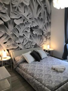 a bedroom with a bed with a floral wall at giolitti central room in Rome