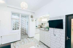 a white kitchen with a sink and a window at Apartments in Uzhgorod in Uzhhorod