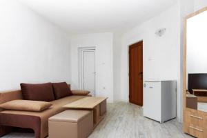 a living room with a couch and a tv at Villa Rezos in Rezovo +49 photos