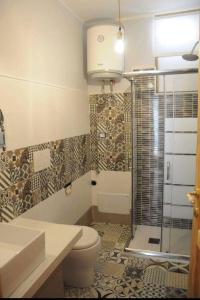 a bathroom with a shower and a toilet and a sink at DONNA FELICIA in Pachino