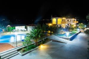 an aerial view of a house and a swimming pool at night at Glyfada Villas in Paralio Astros