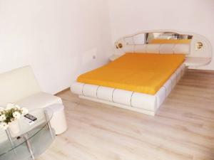 a bedroom with a bed and a couch and a chair at STUDIO SUNRISE in Varna City