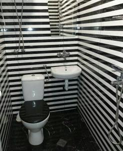 a black and white bathroom with a toilet and a sink at STUDIO SUNRISE in Varna City