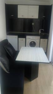 a table and a chair in a room with a washing machine at STUDIO SUNRISE in Varna City