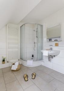 a bathroom with a shower and a sink and a tub at Rent a Home Eptingerstrasse - Self Check-In in Basel