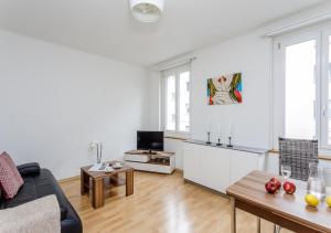 a living room with a couch and a table at Rent a Home Eptingerstrasse - Self Check-In in Basel