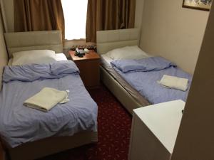 Postel nebo postele na pokoji v ubytování Paris Hotel