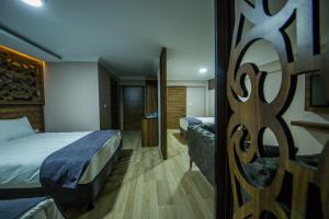Postel nebo postele na pokoji v ubytování Fidanoglu Suite Hotel
