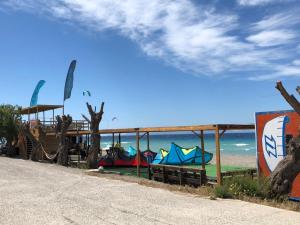 a building with kites on the beach next to the ocean at Retas apartment in Kremasti