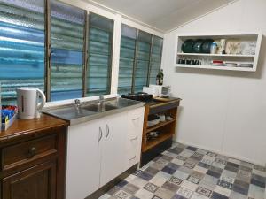 a kitchen with a sink and a window at Meyenburg Units in Mount Morgan