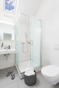 a bathroom with a shower and a toilet and a sink at Swiss Star Marc Aurel - Self Check-In in Zurich
