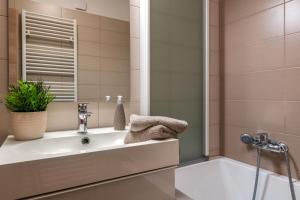 a bathroom with a sink and a shower at Studio Q in Fažana +15 photos