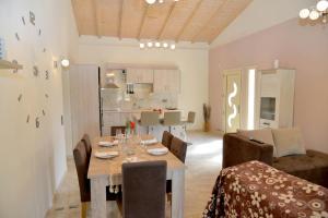 a dining room and kitchen with a table and chairs at ANTIGONH COUNTRYSIDE VILLA !i in Kokkínion