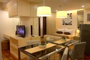 a living room with a couch and a dining room at Prince Plaza II Condotel in Manila