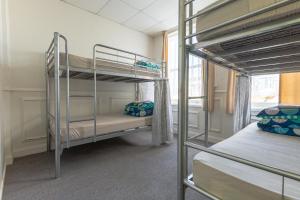 a room with two bunk beds and a window at BK Hostel in Auckland +13 photos