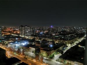 a night view of a city with lights at Departamento Santiago 1148 in Santiago