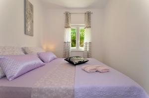 Posteľ alebo postele v izbe v ubytovaní Apartment with a sea view terrace, Čiovo near Trogir