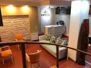 a waiting room with a couch and chairs at Crystal Hotel in La Quiaca