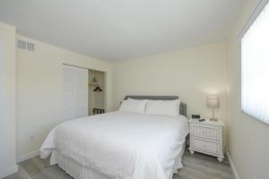 a bedroom with a bed and a dresser at Siesta Key Beach Resort and Suites in Sarasota