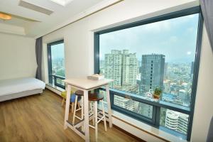 a room with a table and a large window at Luxury House in Taichung