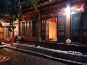 uma casa com sapatos nos degraus em Gongsimga Hanok Guesthouse em Seul