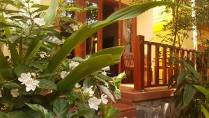 a porch of a house with green plants and flowers at Free Beach Resort in Phú Quốc