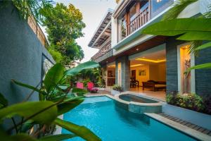 a swimming pool in the backyard of a house at Villa Suzuki 1 Seminyak in Seminyak