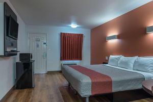 Habitación de hotel con cama y TV en Motel 6-Texarkana, AR, en Texarkana