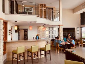 a group of people sitting at a restaurant at Country Inn & Suites by Radisson, Bakersfield, CA in Bakersfield