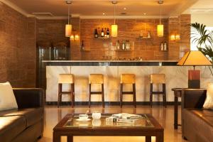 a living room with a couch and a bar at Kamari Beach Hotel in Potos