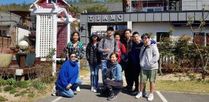 a group of people posing for a picture in front of a building at Gyeongju Tiamo Pension in Gyeongju