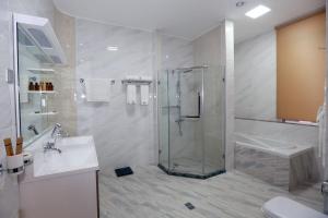 a bathroom with a shower and a sink at Parliament Palace Hotel in Khujand
