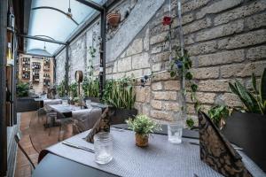 a restaurant with tables and chairs and a brick wall at Ciccio_bed in Agropoli