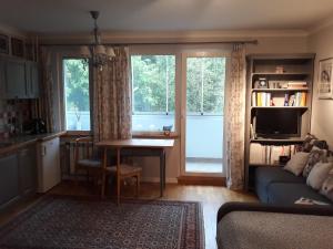 a living room with a couch and a table at Atelier Aleksandry in Gdynia