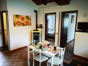 a dining room with a white table and chairs at I Tre Abeti - Holiday House in Vezzano Ligure