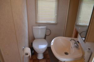 a bathroom with a white toilet and a sink at ZATOR Noclegi u Babci Józi in Zator +52 photos